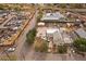 A neighborhood and yard of a home from above and surrounded by adjacent commercial buildings, scrap yard and train tracks at 5182 Thompson Ct, Denver, CO 80216