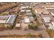 Photo features the rear of a home and detached garage that is situated next to salvage and commercial businesses at 5182 Thompson Ct, Denver, CO 80216