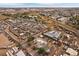 Aerial view looking toward horizon and buildings. The home in surrounded by train tracks and auto salvage yards at 5182 Thompson Ct, Denver, CO 80216