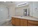 Full bathroom featuring light wood cabinets, white tiled shower, toilet, and a sink with large vanity mirror at 3342 Quail Ridge Cir, Parker, CO 80138