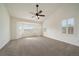 Spacious bedroom with vaulted ceiling, neutral carpet, ceiling fan, and bright bay windows with shutter blinds at 3342 Quail Ridge Cir, Parker, CO 80138