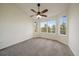 Bright bedroom with plush carpet, large windows, and ample natural light at 3342 Quail Ridge Cir, Parker, CO 80138
