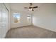 Bedroom with carpet, ceiling fan, two large windows, vaulted ceiling, and a large closet at 3342 Quail Ridge Cir, Parker, CO 80138