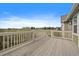 A spacious wooden deck with white railings overlooks a serene landscape and scenic views at 3342 Quail Ridge Cir, Parker, CO 80138