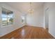 Bright dining room featuring hardwood floors, a chandelier, and large windows at 3342 Quail Ridge Cir, Parker, CO 80138