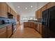 Updated kitchen features stainless steel appliances, wood cabinets, and hardwood floors at 3342 Quail Ridge Cir, Parker, CO 80138