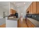 Bright kitchen featuring modern appliances, light wood cabinetry, and an eat-in bar area at 3342 Quail Ridge Cir, Parker, CO 80138