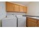 Functional laundry room with washer, dryer, sink, and storage cabinets at 3342 Quail Ridge Cir, Parker, CO 80138