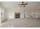 Bright living room with vaulted ceiling, gas fireplace with tile surround, and access to the second floor at 3342 Quail Ridge Cir, Parker, CO 80138