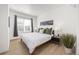 Bright bedroom with a queen-size bed, large window, bedside table, and decorative artwork on the wall at 1495 Zamia Ave # 3, Boulder, CO 80304