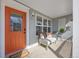 Inviting front porch with comfortable seating, offering a relaxing outdoor space and a bright orange front door at 1495 Zamia Ave # 3, Boulder, CO 80304