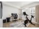 Well-lit home office featuring a desk setup, office chair, and an exercise bike at 1495 Zamia Ave # 3, Boulder, CO 80304