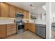 Kitchen boasting stainless steel appliances, wooden cabinets, and white countertops with an opening to the living area at 1495 Zamia Ave # 3, Boulder, CO 80304