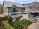 Back exterior view of the home shows a large backyard, patio, and well-maintained landscaping at 700 Cheyenne St, Golden, CO 80401