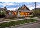 Charming home with a covered front porch, well-maintained lawn, and beautiful landscaping with mountain views at 700 Cheyenne St, Golden, CO 80401