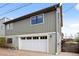 Attached garage with large white door and ample parking space, complemented by modern exterior lighting fixtures at 700 Cheyenne St, Golden, CO 80401