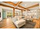 Open-concept living room features wood beams, hardwood floors, and a large sectional sofa at 700 Cheyenne St, Golden, CO 80401