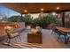 Inviting covered patio with a brick fireplace, comfortable seating, and a dining area for outdoor enjoyment at 700 Cheyenne St, Golden, CO 80401
