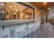 Outdoor bar with seating offers views into the kitchen and access to the covered patio area at 700 Cheyenne St, Golden, CO 80401