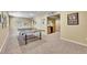 Basement game area with ping pong table, kitchenette, and carpeted floor at 14878 E Aberdeen Ave, Centennial, CO 80016