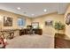 Finished basement features a desk, piano, and chair with ample lighting at 14878 E Aberdeen Ave, Centennial, CO 80016