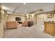 Finished basement featuring a media area, sitting space, and kitchenette at 14878 E Aberdeen Ave, Centennial, CO 80016