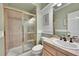 Bathroom features a walk in shower with a glass door, a vanity and toilet at 14878 E Aberdeen Ave, Centennial, CO 80016