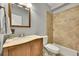 The bathroom offers a vanity and a shower with tile and bronze fixtures at 14878 E Aberdeen Ave, Centennial, CO 80016