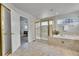 Bathroom with a shower and large tub featuring tile surround and a transom window at 14878 E Aberdeen Ave, Centennial, CO 80016
