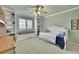 Green bedroom featuring a white daybed, bookshelves, and natural lighting from a window at 14878 E Aberdeen Ave, Centennial, CO 80016