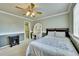Bedroom featuring a bed, desk and an adjoining closet with ample space for storage at 14878 E Aberdeen Ave, Centennial, CO 80016
