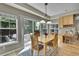 Bright dining area with wood floors and sliding door to the outdoor patio at 14878 E Aberdeen Ave, Centennial, CO 80016