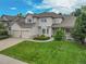 Attractive home featuring lush green grass, mature trees, and a three-car garage for convenience and curb appeal at 14878 E Aberdeen Ave, Centennial, CO 80016