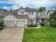 Inviting home with a well-manicured lawn, three-car garage and a charming covered porch, perfect for relaxing outdoors at 14878 E Aberdeen Ave, Centennial, CO 80016
