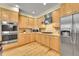 Updated kitchen features stainless steel appliances, and light wood cabinets at 14878 E Aberdeen Ave, Centennial, CO 80016