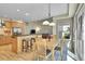 Bright eat-in kitchen seamlessly connected to a dining area, featuring an island, and natural light, perfect for casual dining at 14878 E Aberdeen Ave, Centennial, CO 80016