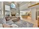 Spacious living room with fireplace, many windows, and open to the kitchen at 14878 E Aberdeen Ave, Centennial, CO 80016
