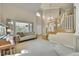 Bright and airy living room with soaring ceilings, large windows, and a staircase, creating a welcoming and open space at 14878 E Aberdeen Ave, Centennial, CO 80016