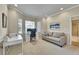 Office room with natural light, neutral colors, and a comfortable couch at 14878 E Aberdeen Ave, Centennial, CO 80016