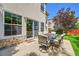 Covered patio with stone accents, backyard views, and outdoor seating at 14878 E Aberdeen Ave, Centennial, CO 80016