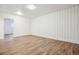 Finished basement with laminate flooring and white wainscotting at 4624 S Lincoln St, Englewood, CO 80113