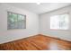 Cozy bedroom showcasing hardwood floors and ample natural light streaming through the windows at 4624 S Lincoln St, Englewood, CO 80113