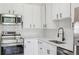 Stylish kitchen with stainless steel appliances, white cabinets and modern fixtures at 4624 S Lincoln St, Englewood, CO 80113