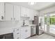 Modern kitchen featuring white cabinets, stainless steel appliances, and subway tile backsplash at 4624 S Lincoln St, Englewood, CO 80113