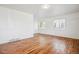 Spacious living room featuring hardwood floors and multiple windows for natural light at 4624 S Lincoln St, Englewood, CO 80113