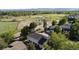 Aerial view of the neighborhood showcasing lush greenery, nearby road and views of the surrounding mountains at 2557 S Dover St # 85, Lakewood, CO 80227