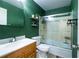 Bathroom with a shower-tub combo, wooden vanity and trendy floating shelves for storage at 2557 S Dover St # 85, Lakewood, CO 80227