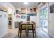 Bright dining area featuring a wooden table, seating for four, and access to the backyard at 2557 S Dover St # 85, Lakewood, CO 80227