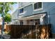 Charming townhome features light-blue siding, a covered front porch, and a privacy fence at 2557 S Dover St # 85, Lakewood, CO 80227