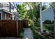 Charming front yard with a wooden fence, lush greenery, and pathway leading to the entrance at 2557 S Dover St # 85, Lakewood, CO 80227